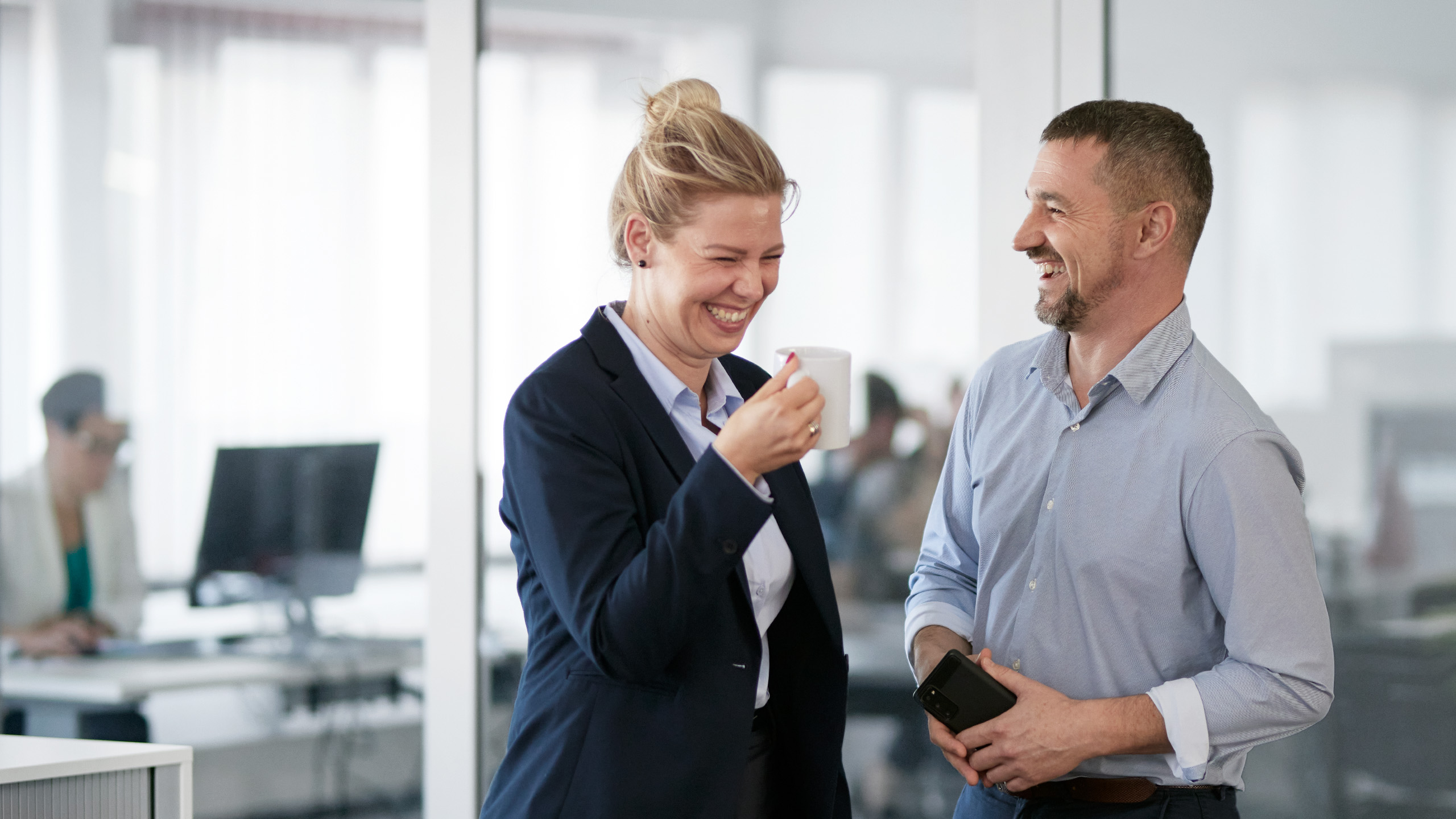 a man and a woman looking at a tablet
