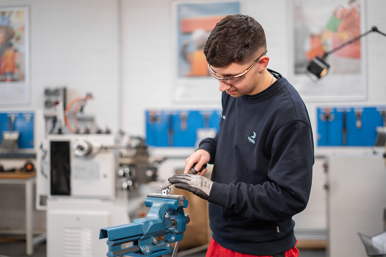 a man working on a blue piece of metal