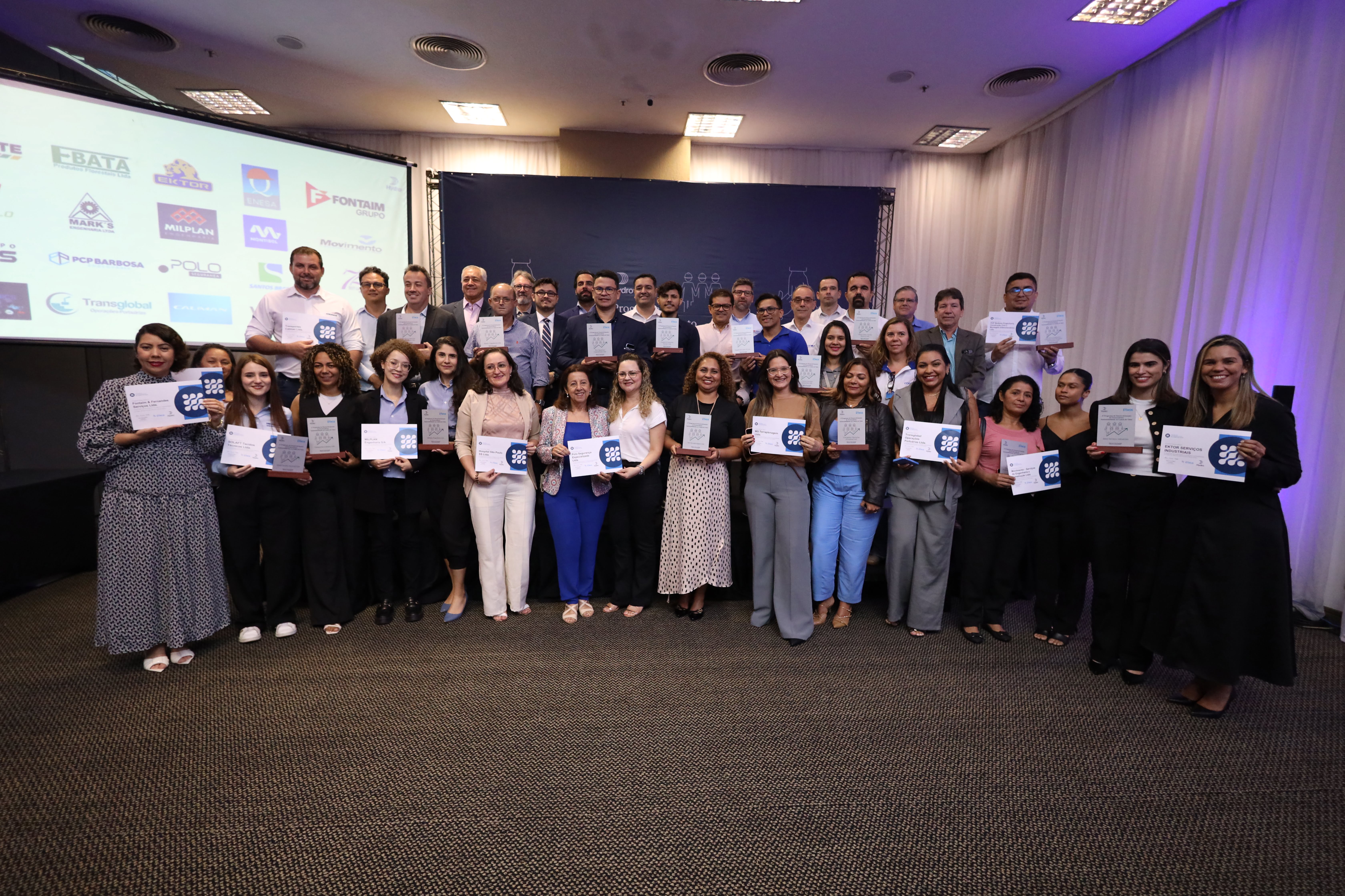 a group of people holding certificates