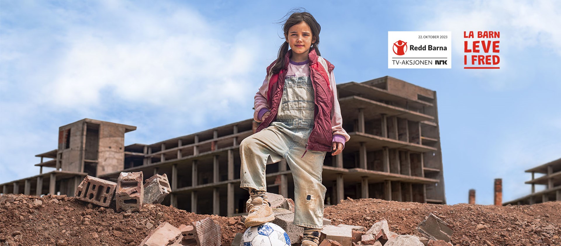 Girl with a ball in front of a building