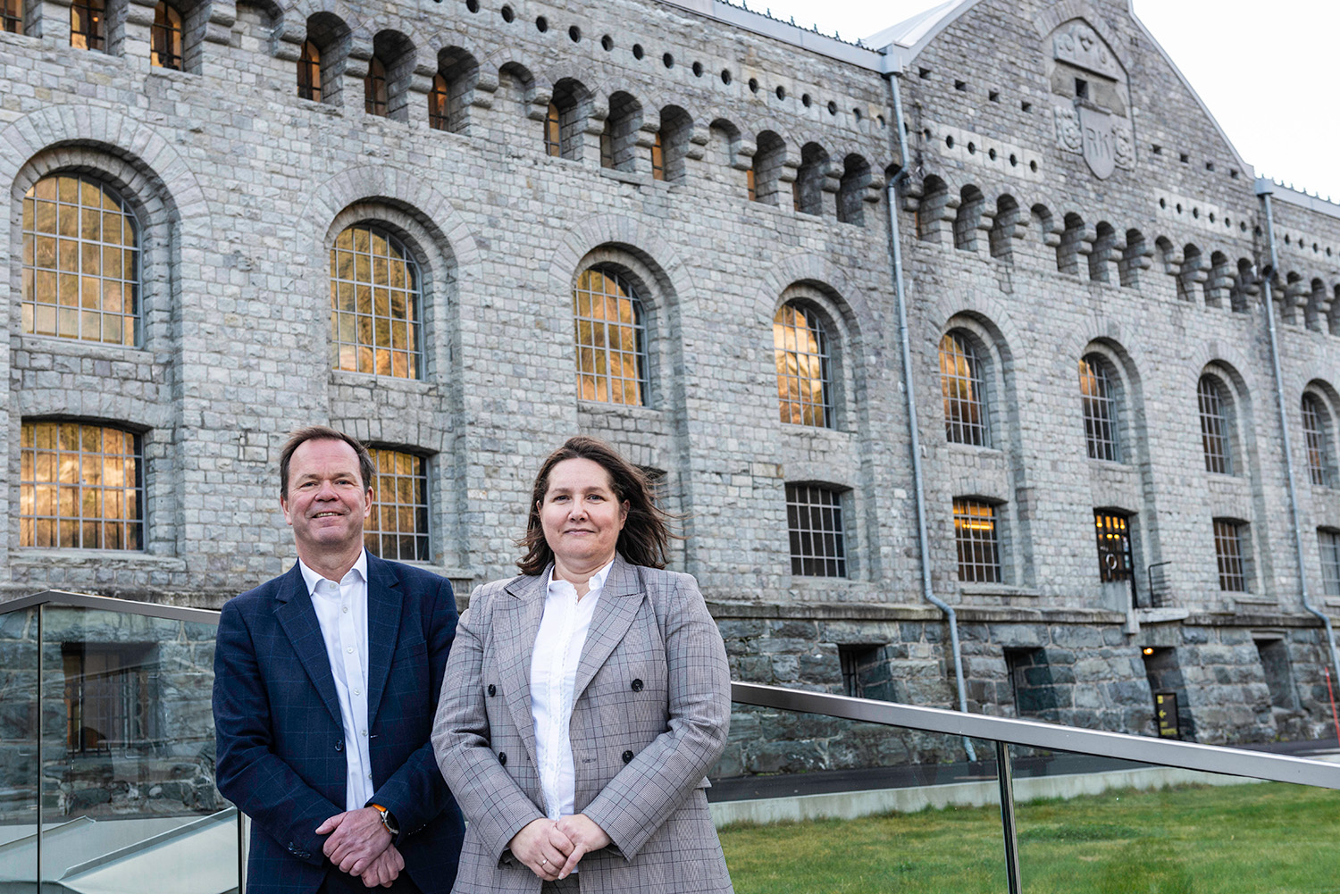 a man and a woman standing in front of building 