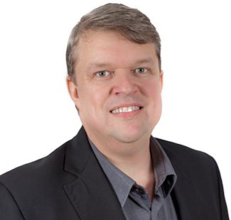 a man wearing a black suit