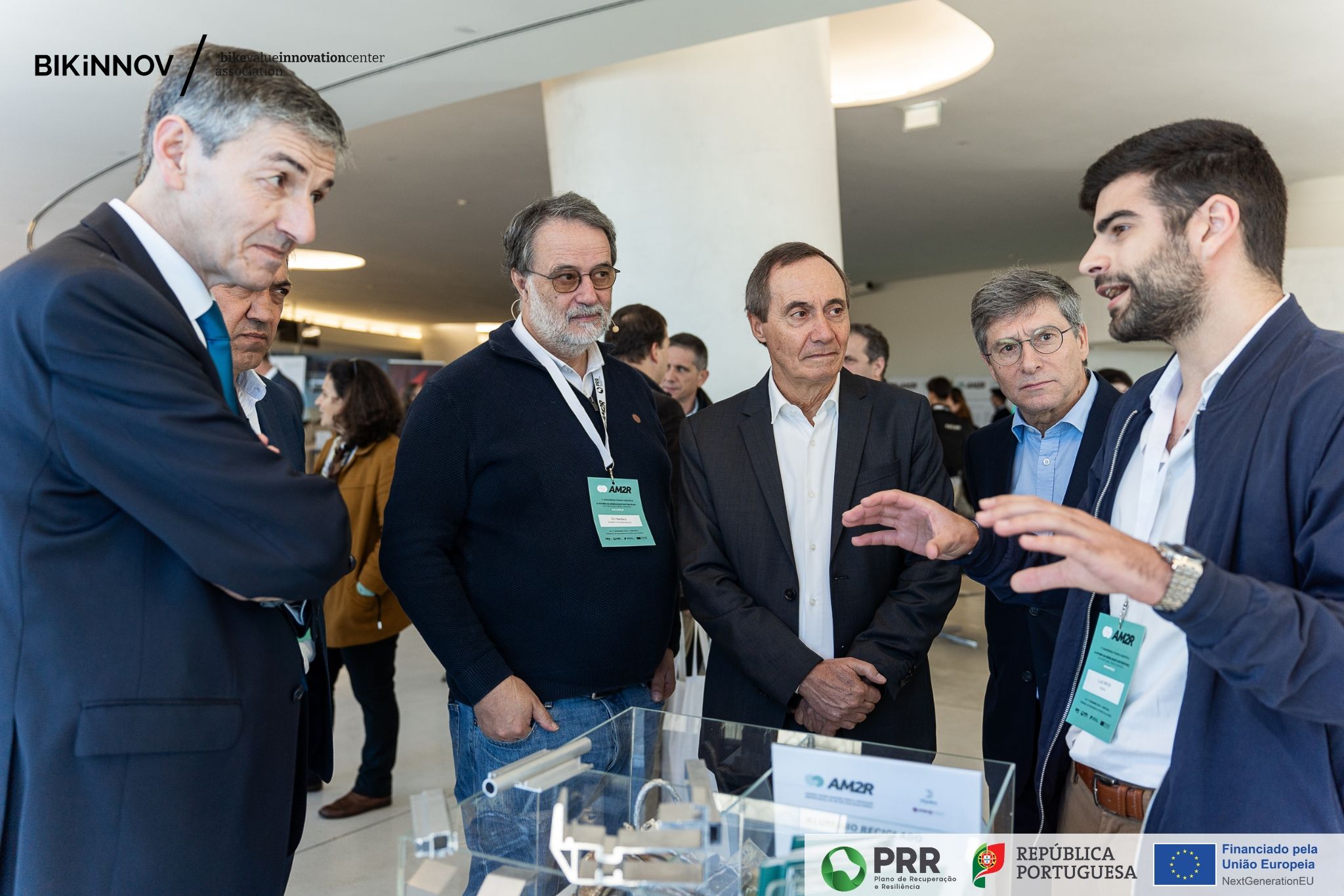 a group of men standing around a table with aluminium profiles