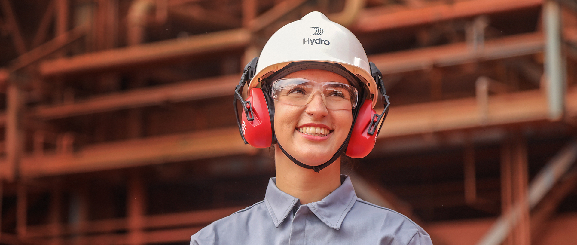 a woman wearing a hard hat and earmuffs