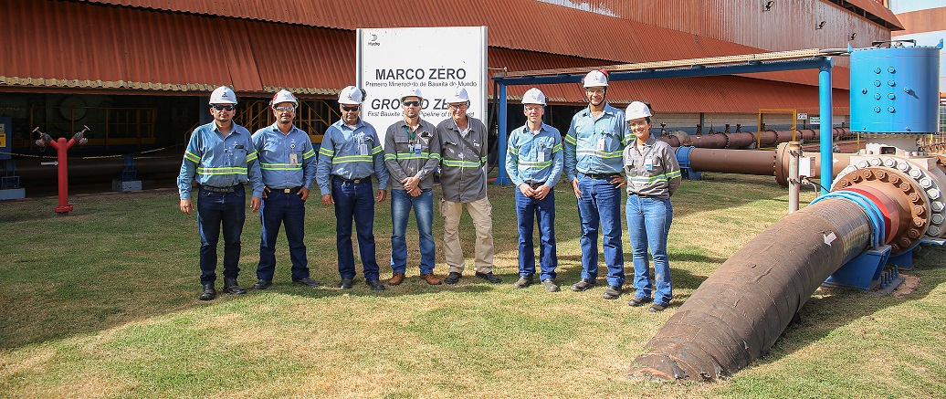 a group of men wearing hardhats standing in front of a building