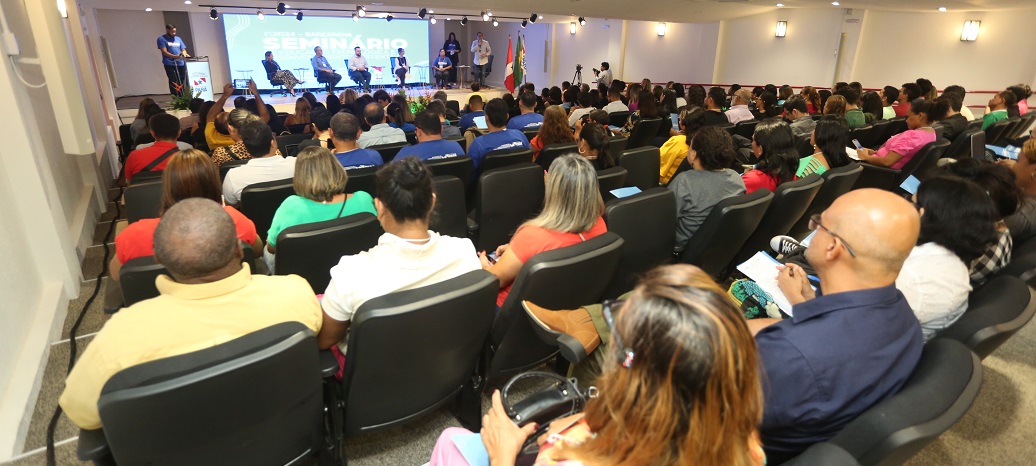 a group of people sitting in a room with a projector screen