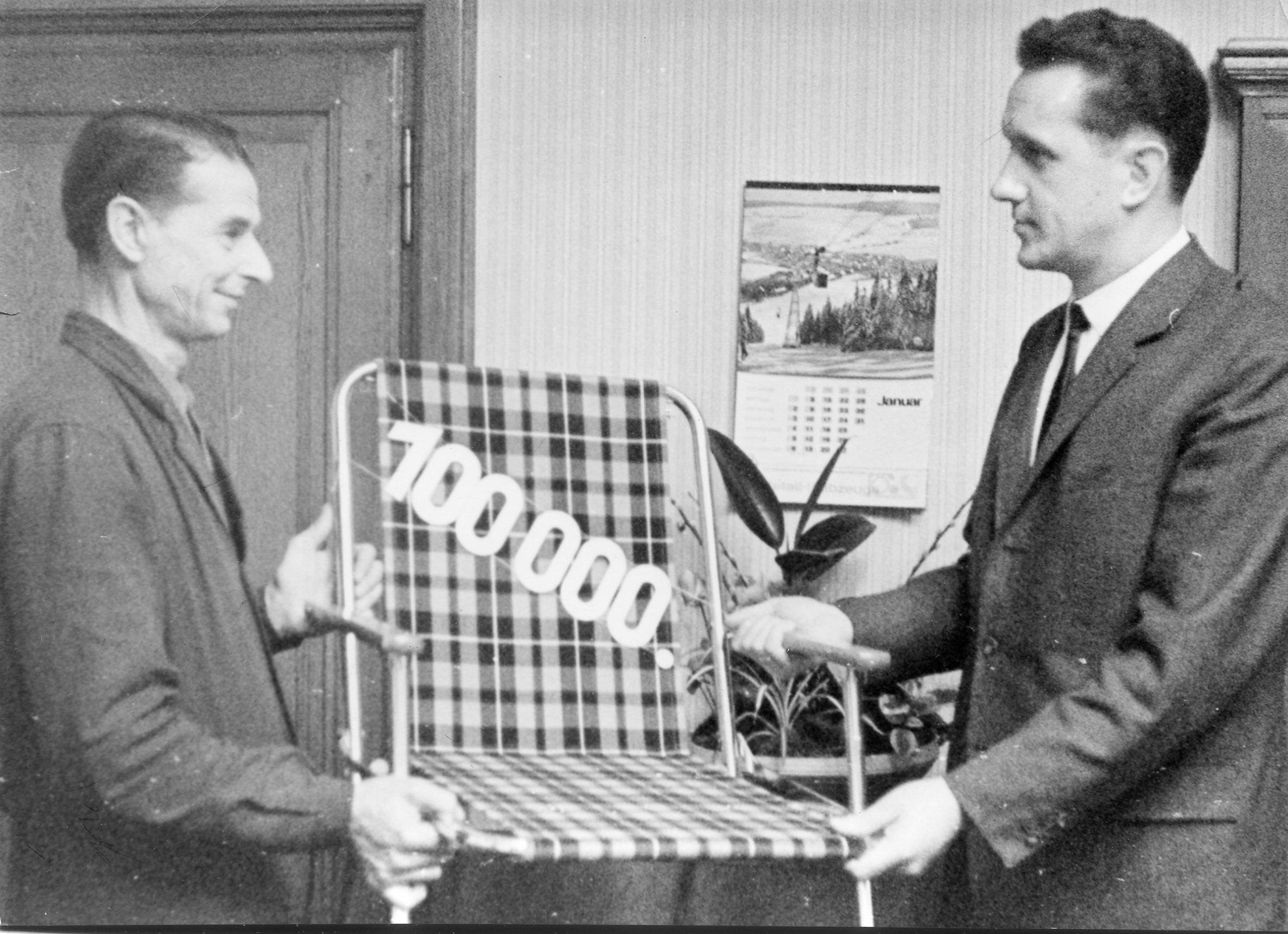 two men holding a chair