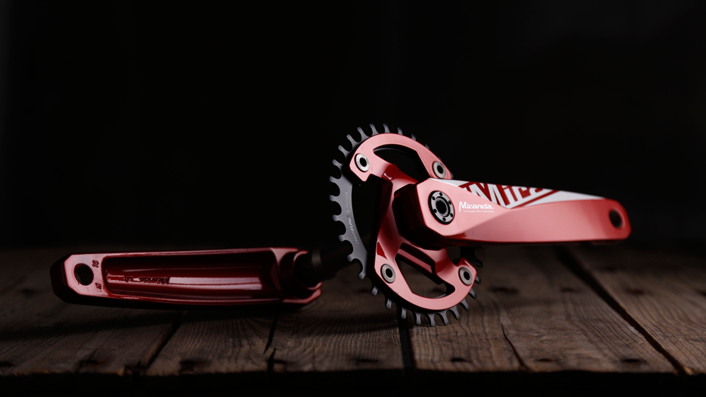 a pair of red and white roller blades on a wooden surface